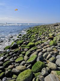 Scenic view of rocks on beach against sky