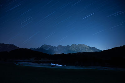 Scenic view of mountains against sky at night