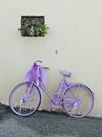 Bicycle parked against wall