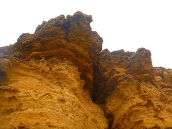 Low angle view of rock formation against clear sky