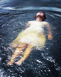 Woman with casual clothing floating on water