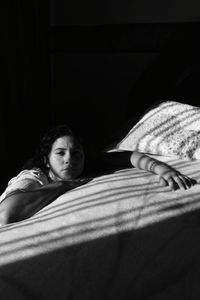 Portrait of woman relaxing on bed at home