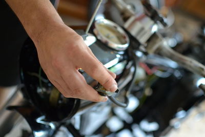 Close-up of mechanic repairing car