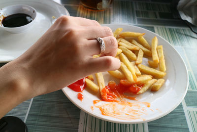 High angle view of person preparing food on plate