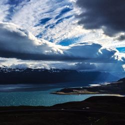 Scenic view of mountains against cloudy sky