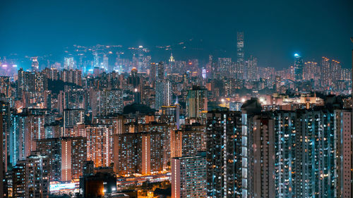 Illuminated cityscape against sky at night