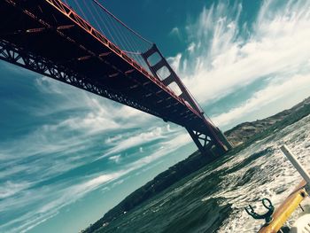 Low angle view of bridge over sea against sky