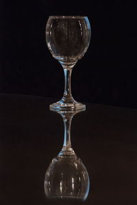 Close-up of glass on table against black background