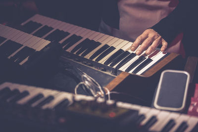 Midsection of man playing piano