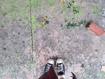 Low section of person standing on footpath