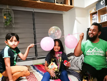 High angle view of happy friends with balloons