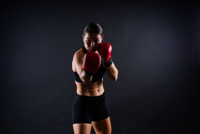 Side view of woman exercising in gym