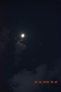 Low angle view of illuminated lights against sky at night