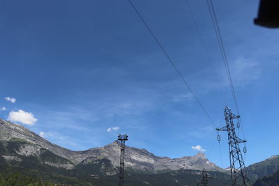 Low angle view of electricity pylon against sky