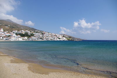 Scenic view of sea by buildings against sky