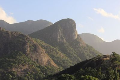 Scenic view of mountains against cloudy sky