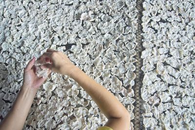 Close-up of woman standing on tiled floor