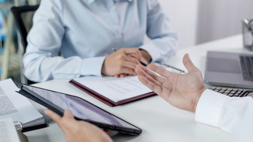 Midsection of doctor working on table