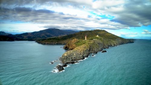 Scenic view of sea and mountains against sky