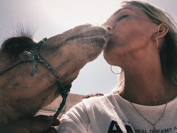 Close-up of couple kissing dog