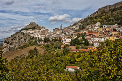 Houses on mountain against sky