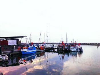 Boats moored at harbor