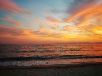 Scenic view of sea against romantic sky at sunset