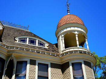 Low angle view of building against clear blue sky