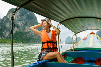 Rear view of woman sitting in boat