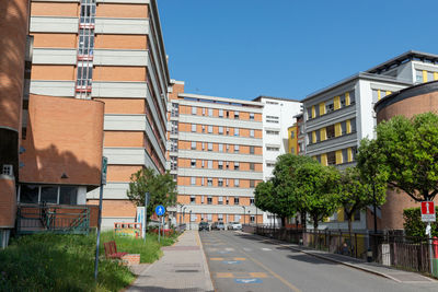 Street amidst buildings against sky