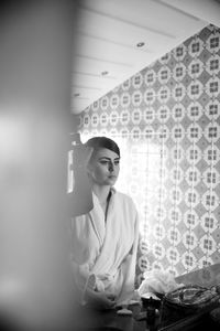 Portrait of woman looking away while sitting on table