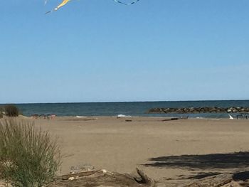 Scenic view of beach against clear sky