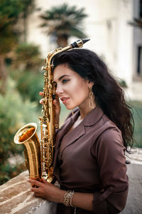 Portrait of young woman playing outdoors