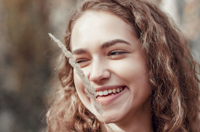 Close-up of smiling young woman looking away