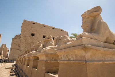 Statues at old ruins against clear sky