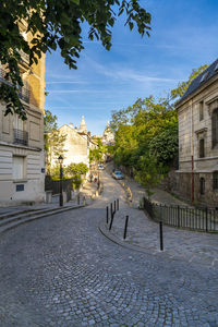 Street amidst buildings against sky
