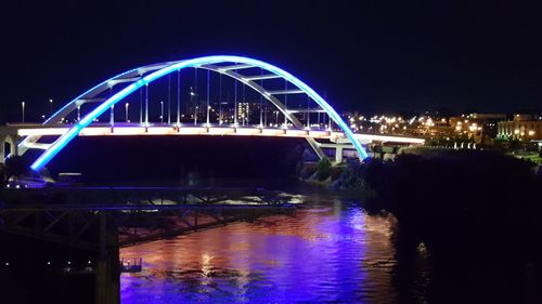 Illuminated bridge over river