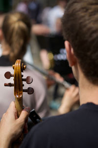 Rear view of people playing guitar