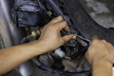 High angle view of man working on metal