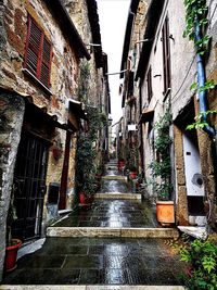 Narrow alley amidst old buildings in city