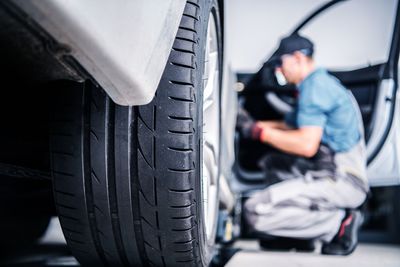 Mechanic working on car at workshop