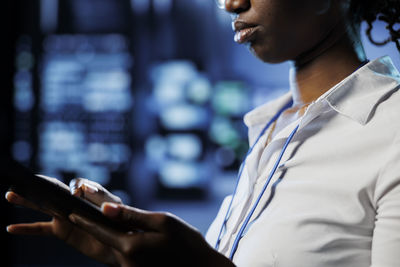 Midsection of woman using mobile phone