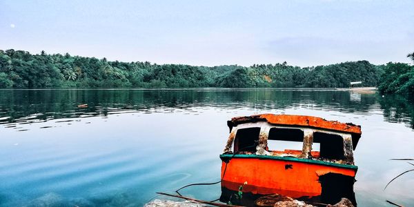 Boat on lake against sky