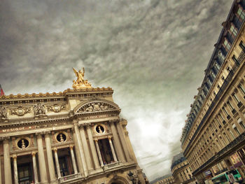 Low angle view of historical building against cloudy sky