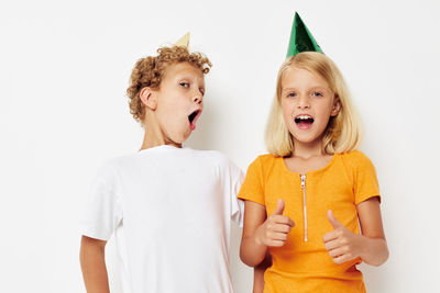 Smiling sibling against white background