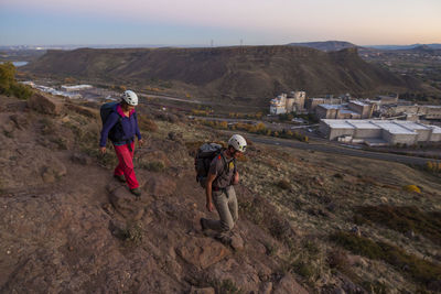 Rock climbers hike trail at north table mountain, golden, colorado