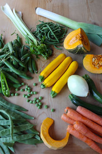 Multicolored vegetables on wooden table view from above. food background. vertical