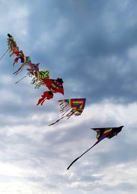 Low angle view of flag flying against sky