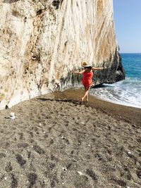 Rear view of walking at beach