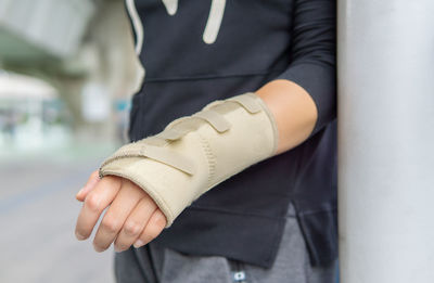 Midsection of man with fractured hand